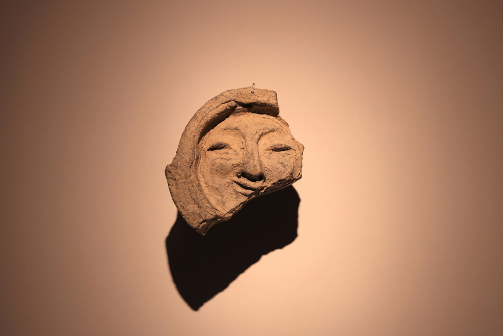 Front view of the “Smile of Silla,” a human-face tile from the Silla period at the National Gyeongju Museum. This timeless design inspired the APEC 2025 Korea emblem, alongside a butterfly symbol of connection and innovation.